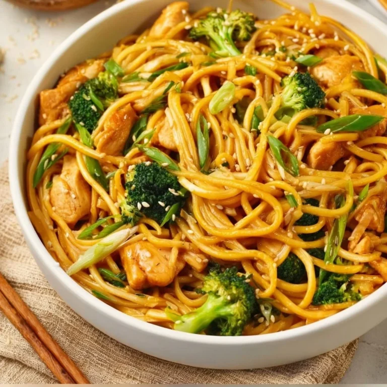 Delicious plate of Sesame Chicken served with Lo Mein noodles on a vibrant table.