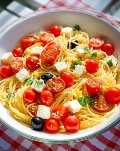 Delicious classic spaghetti pasta salad with fresh vegetables and herbs