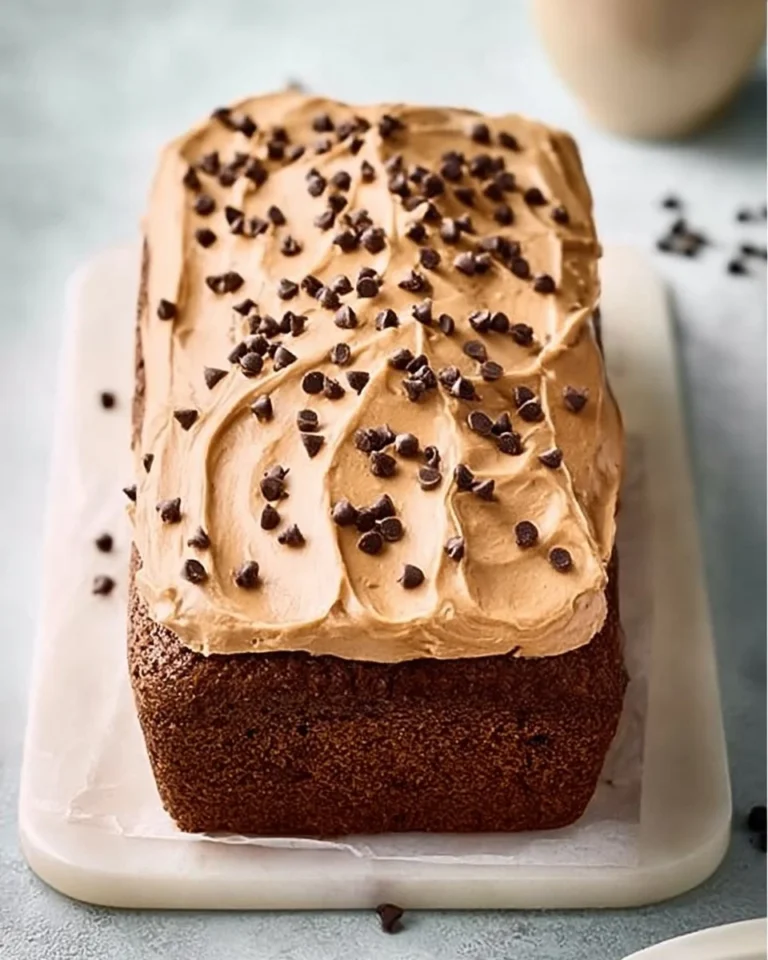 Delicious chocolate loaf cake slice on a plate, ideal for tea time.